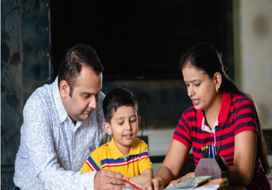 A tutor explaining a maths problem on a whiteboard to a young boy